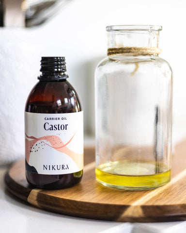 250ml bottle of castor oil next to a jar where some of it has been poured into