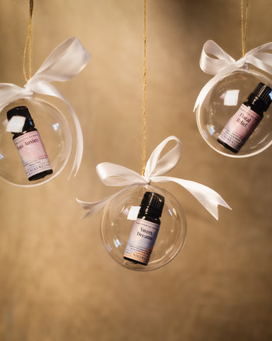 Three essential oil blends within three clear baubles hung up