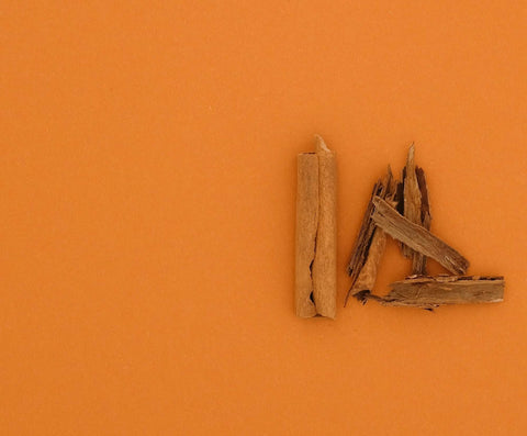 Cinnamon sticks with orange background