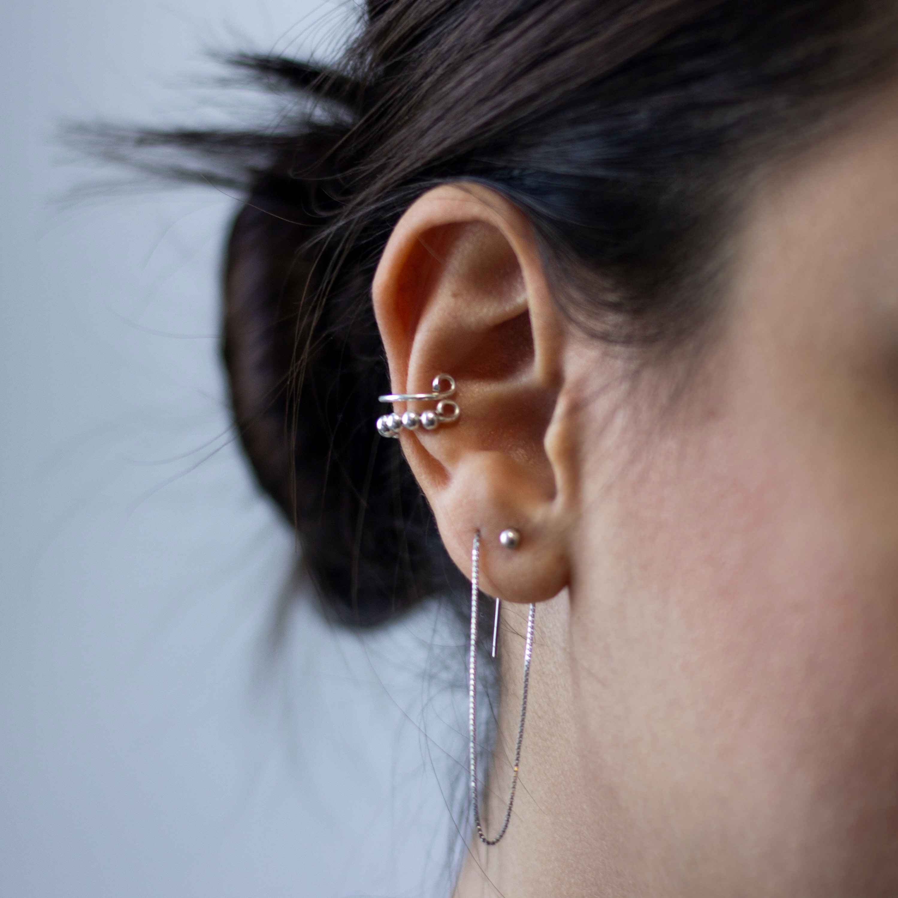Woman showing off her ear piercings.