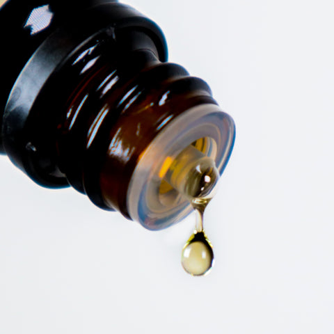 Dropper bottle with drop of oil