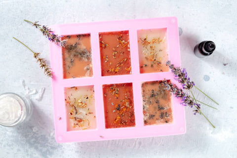 Silicone soap tray with melted soap base sprinkled with botanicals
