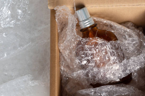 Perfume bottle in a box with bubble wrap around it