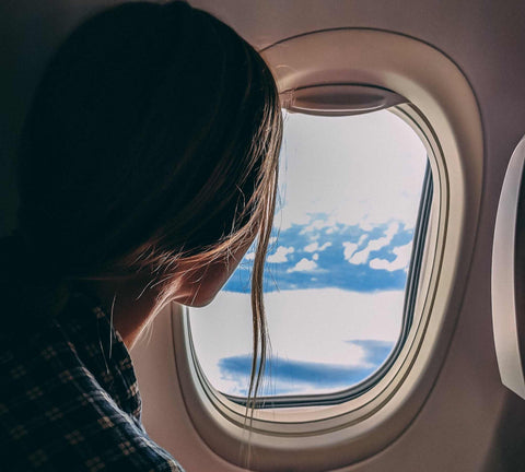 Someone looking out of a plane window