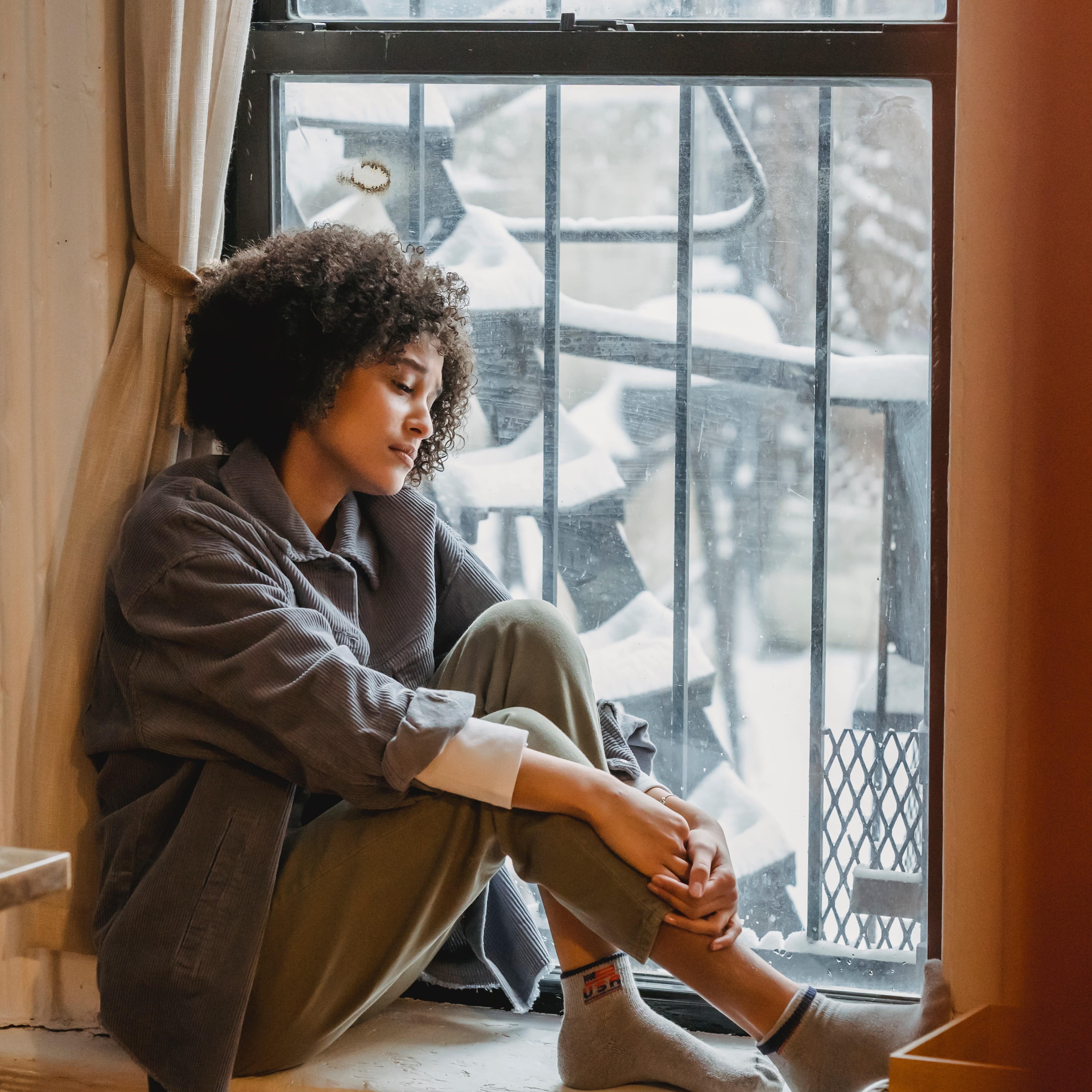 Woman looking out of the window.