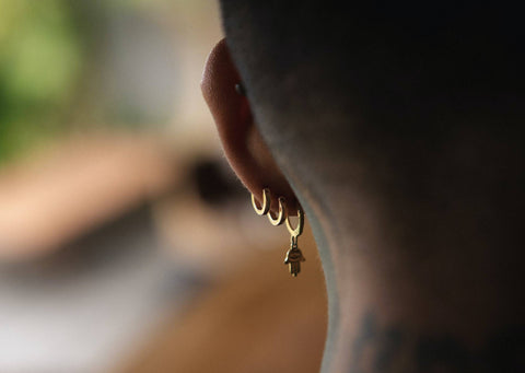 View of the side/back of someones head where you can see their ear piercings