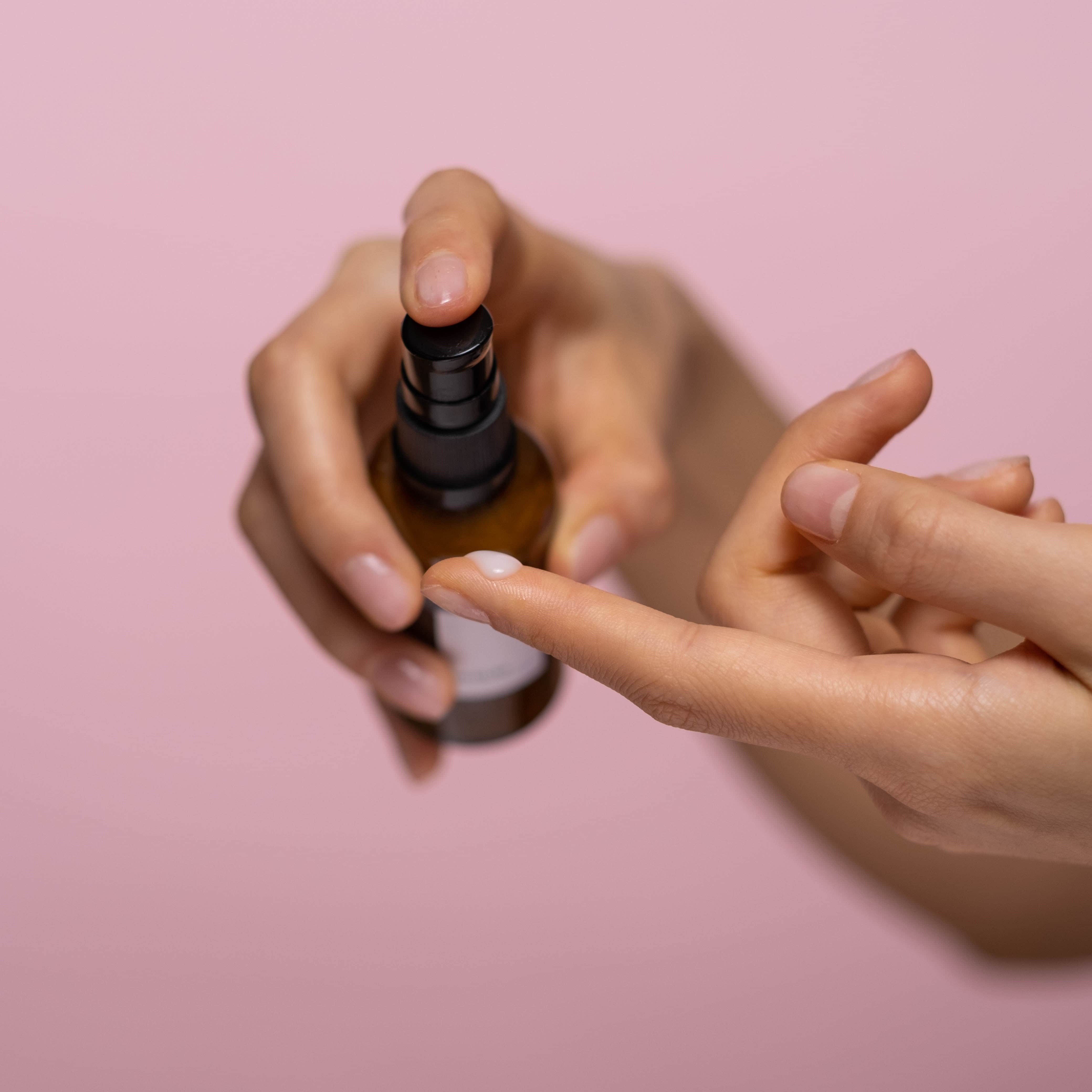 Person putting moisturiser onto finger.