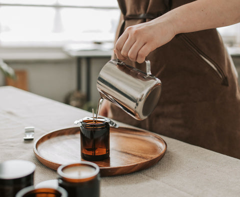 Pouring candles with a metal jug