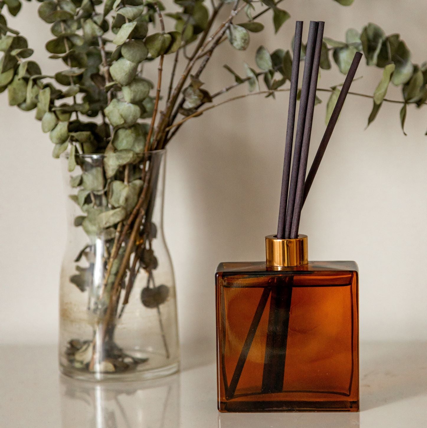 Amber Glass bottles with dried patchouli herbs surrounding