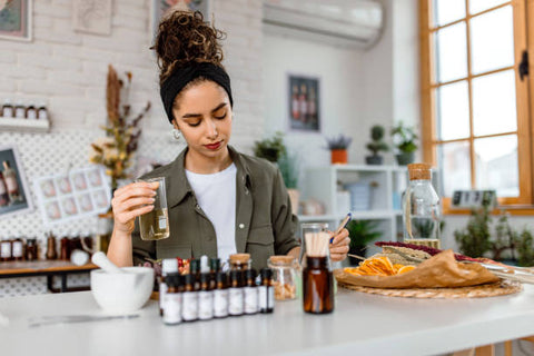 Woman mixing perfume at a desk