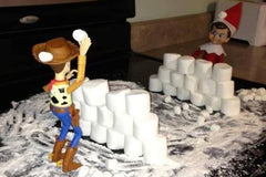 Elf on Shelf and Wooden Having Snowball Fight.  Image from Pinterest, via Netmums