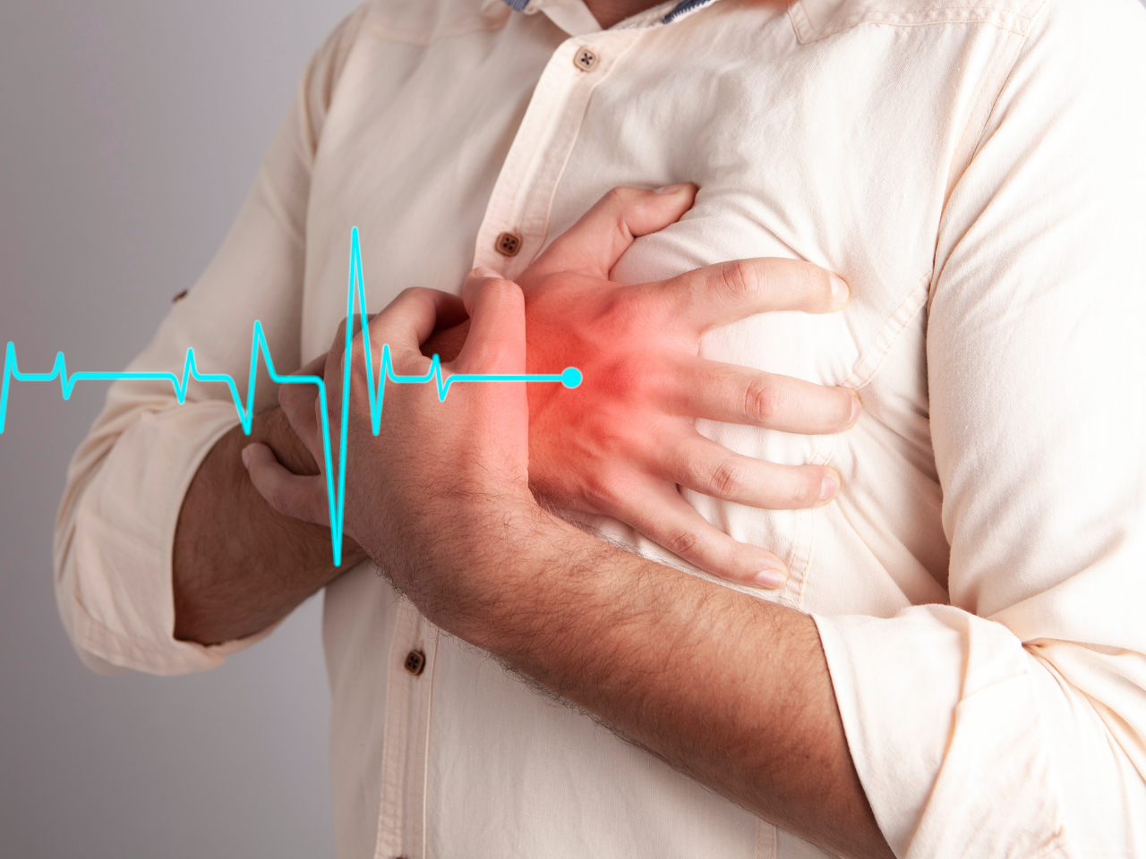 Man clutching chest due to chest pain and heart problems