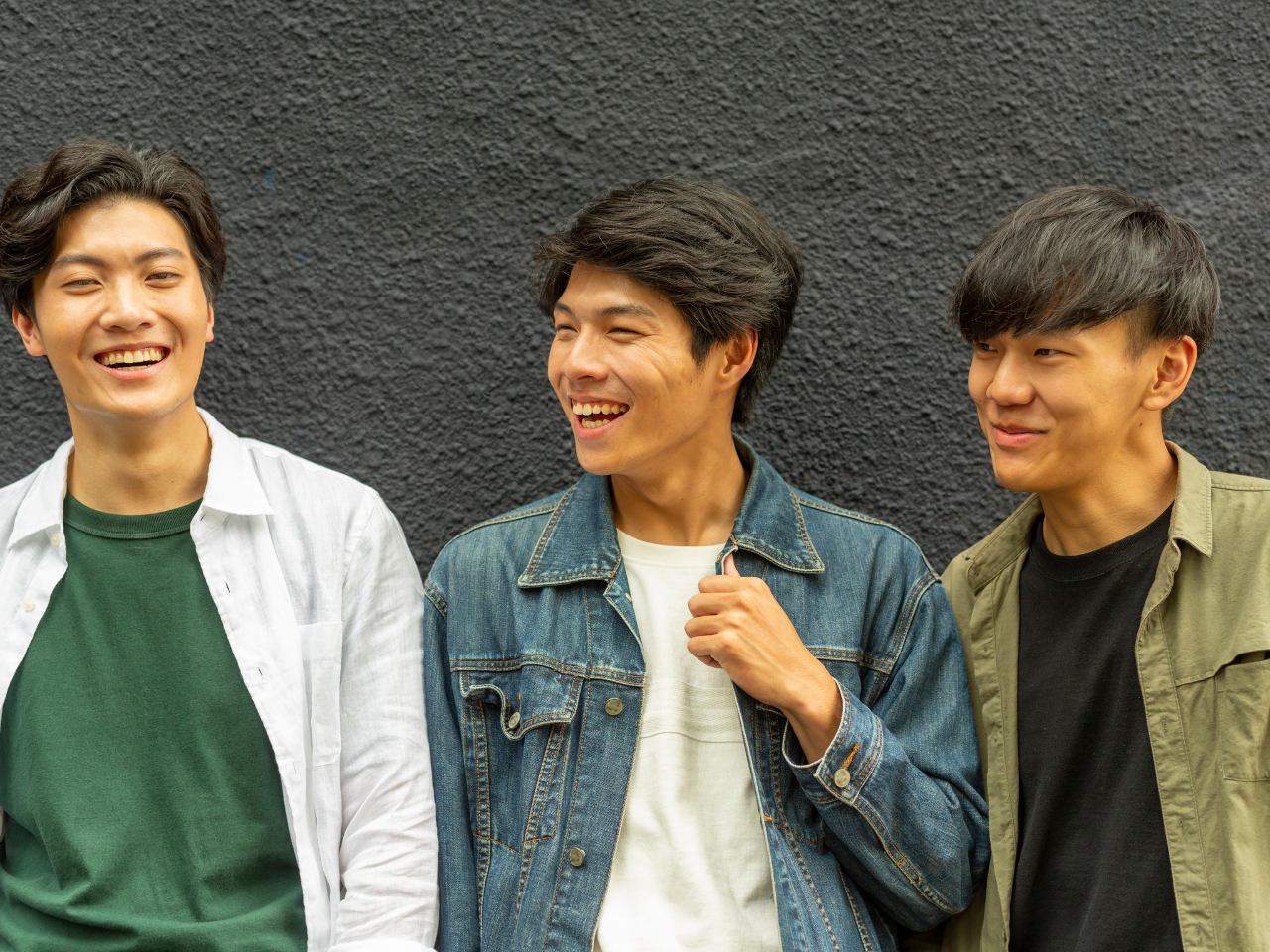 Three young asian men smiling
