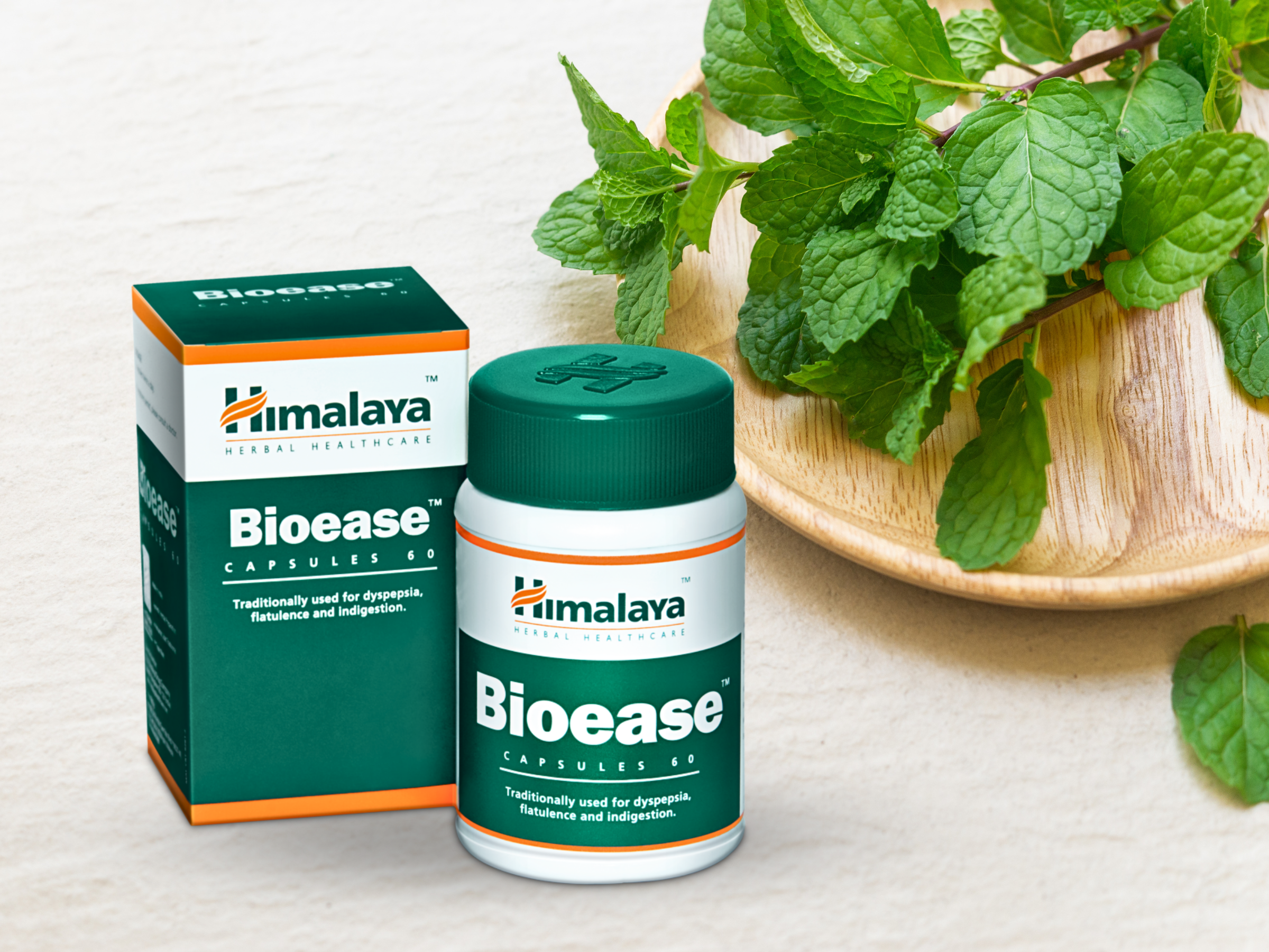 Himalaya Bioease product placed on a table with peppermint leaves at the side