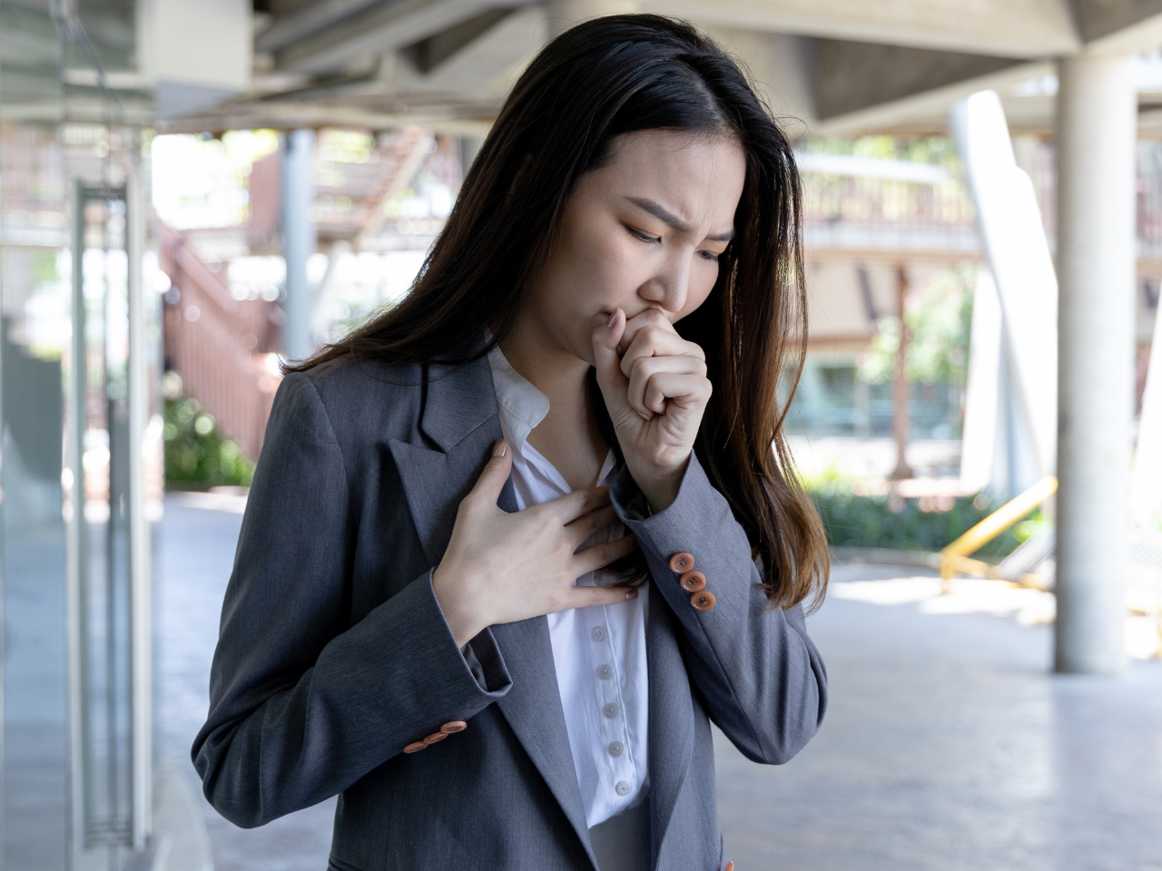 Asian woman coughing