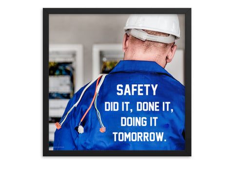 Safety poster showing an electrician wearing a hard hat and holding cables working on an electrical panel with text on the back of his bright blue shirt.