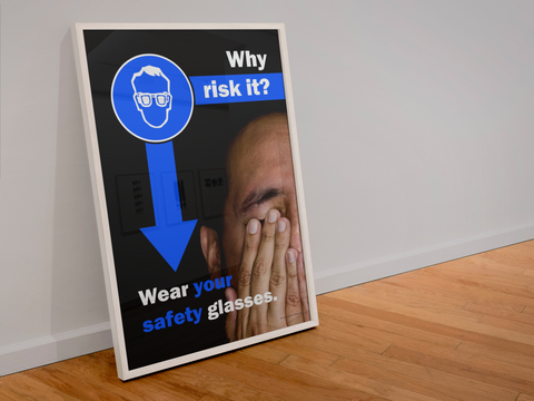 An eye safety poster of a close up of half of a man's face covering his eyes with his hands with safety slogans above him and to the left.