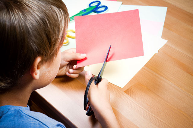 kid cutting craft paper