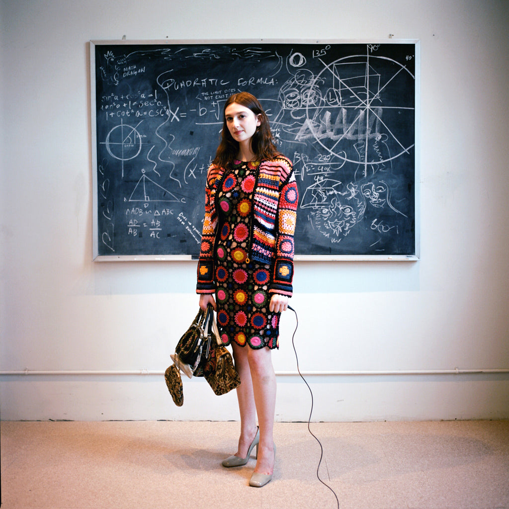 model in crochet with a handful of vintage bags.