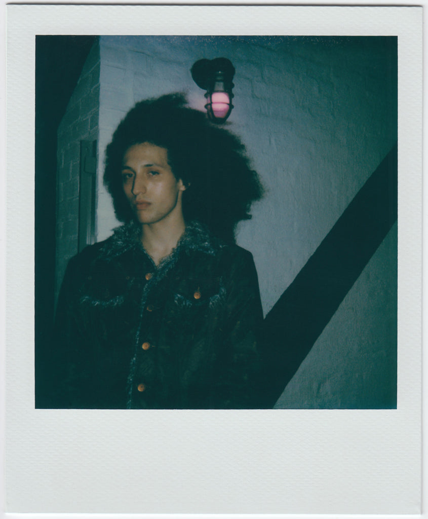 erson pposing for the camera, hair blowing in the wind - polaroid style.
