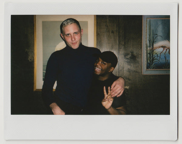 employees posing for the camera, one making 'peace and love' gesture with hands – polaroid style.