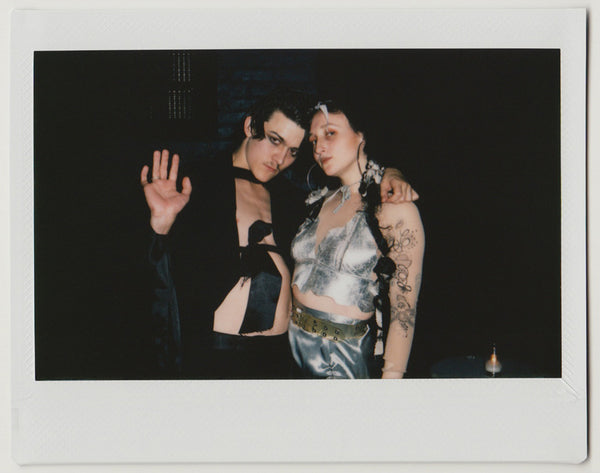 two employees next to each other, posing - polaroid style.