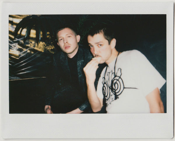 employees posing, one eating a pizza slice – polaroid style.