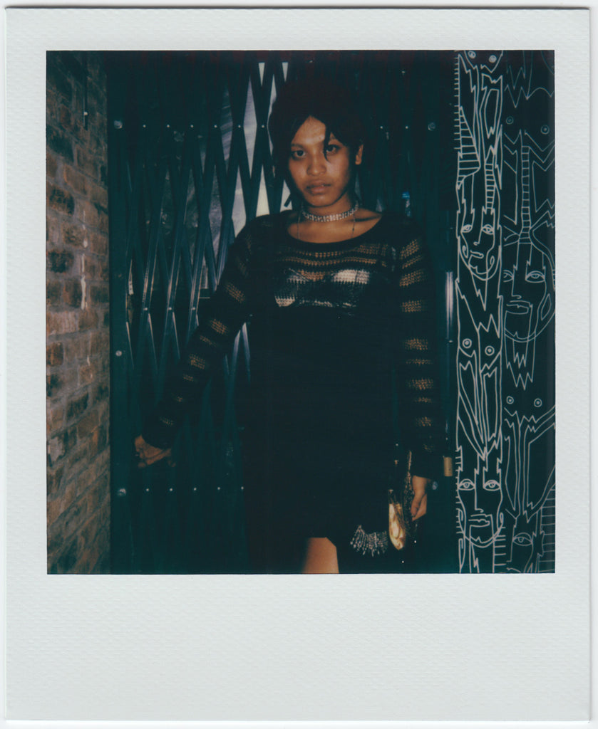 person posing, looking at camera - polaroid style.