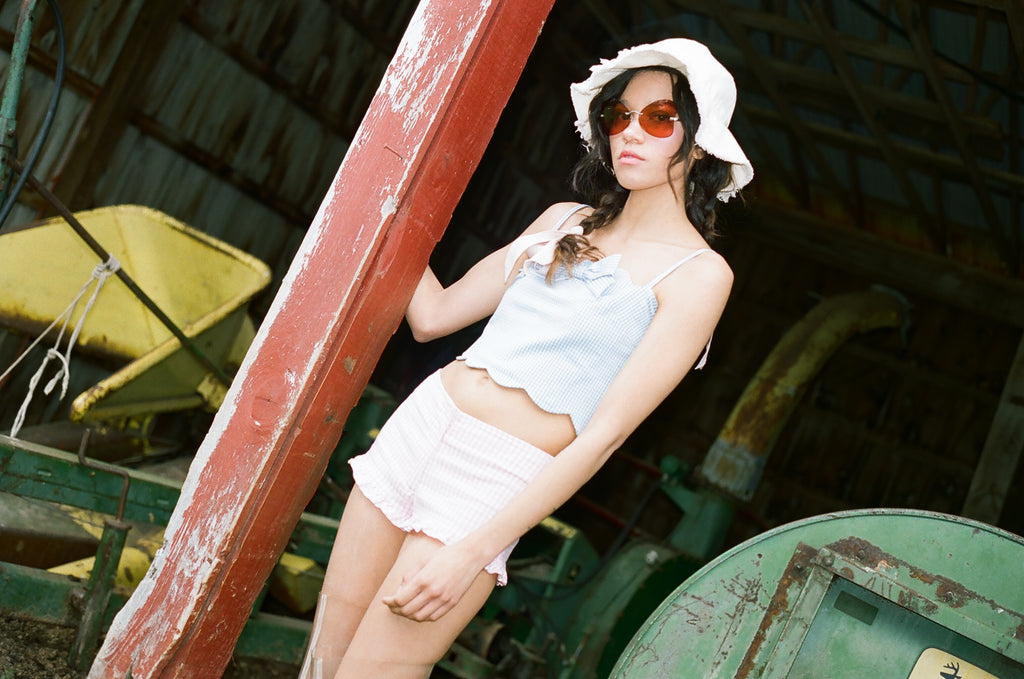 model posing in front of abandoned dairy barn.