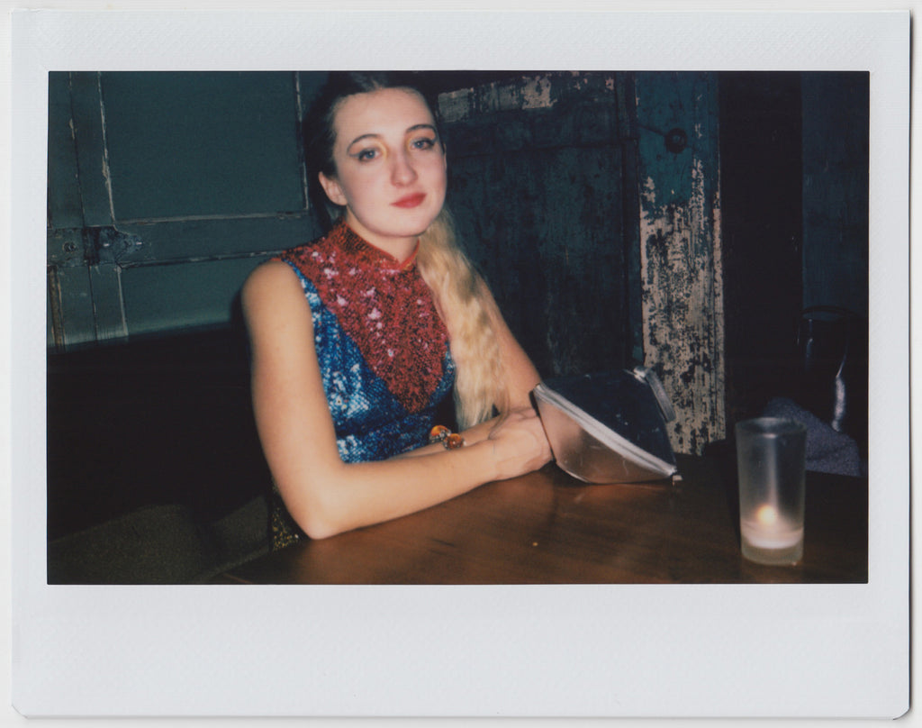 person sitting at the table, looking at the camera - polaroid style. 