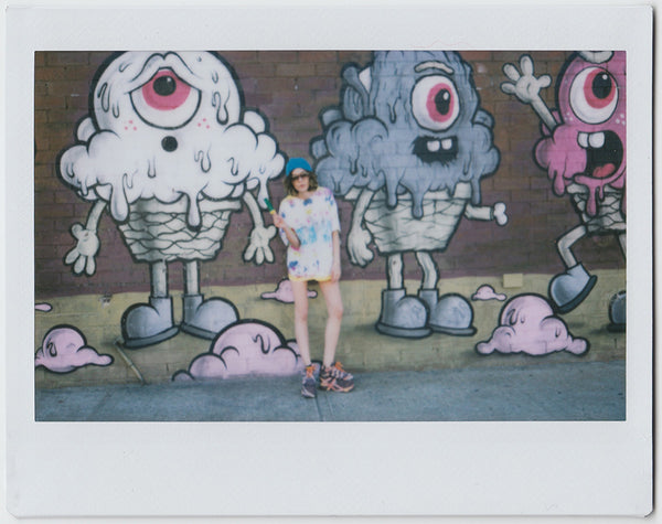 aisha gunnell wearing a tie dye shirt in front of ice cream murals in bushick.