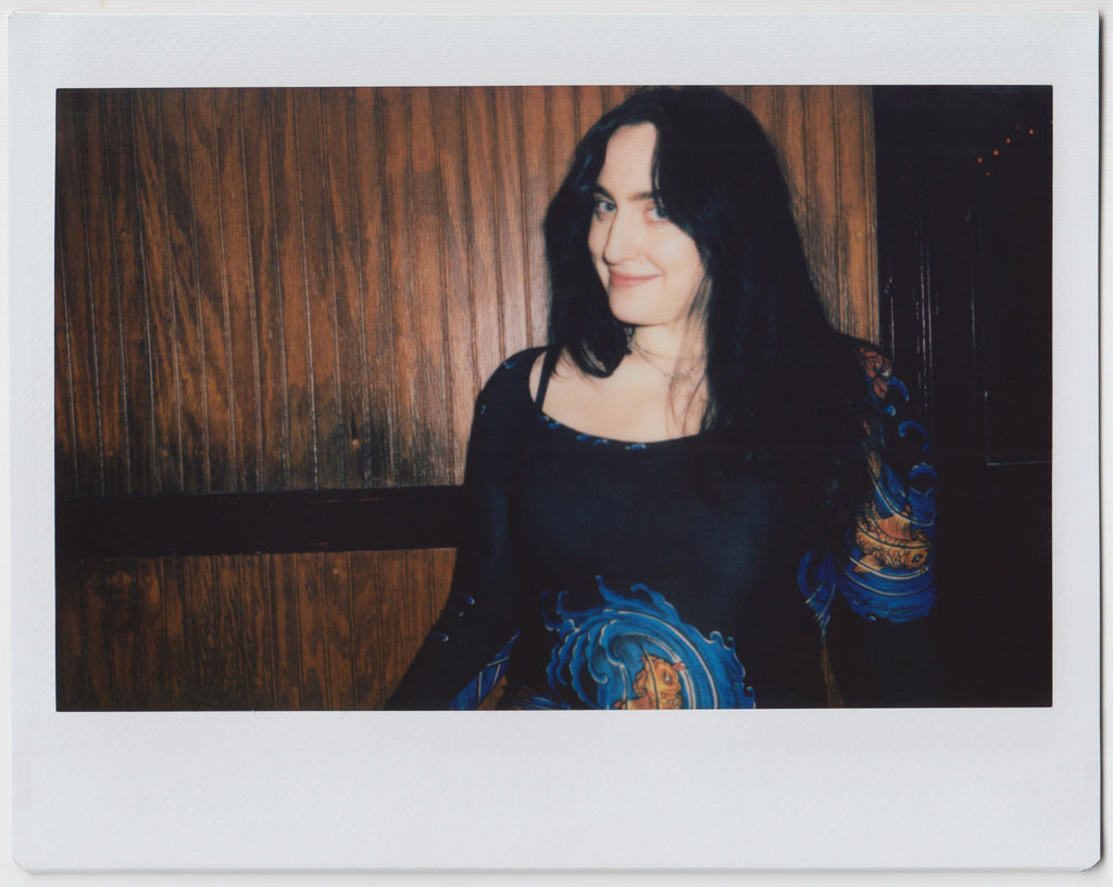 person slightly smiling at camera - polaroid style. 