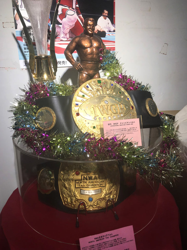 a boxing belt on display in a display case.