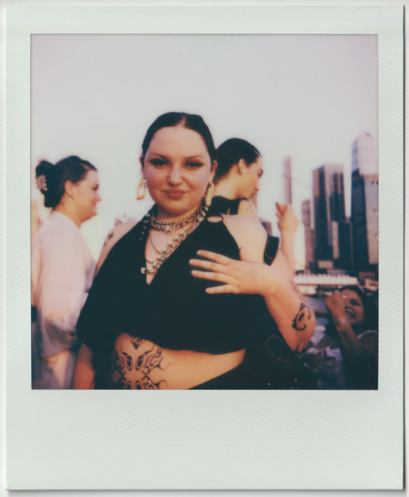 employee posing to the camera, hands on chest - polaroid style.