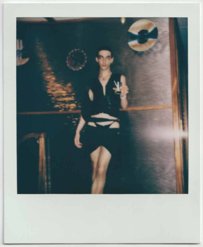 employee posing, holding drink - polaroid style.