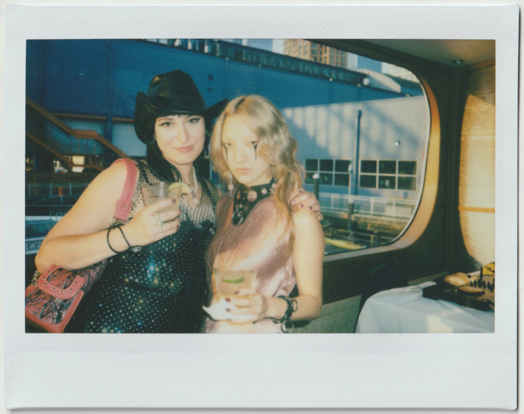 two employees next to each other, posing - polaroid style.