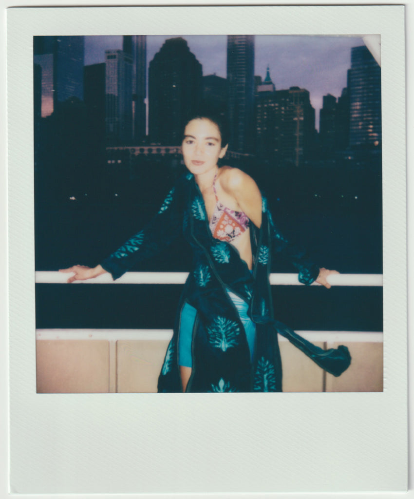 model posing, manhattan skyline behind.