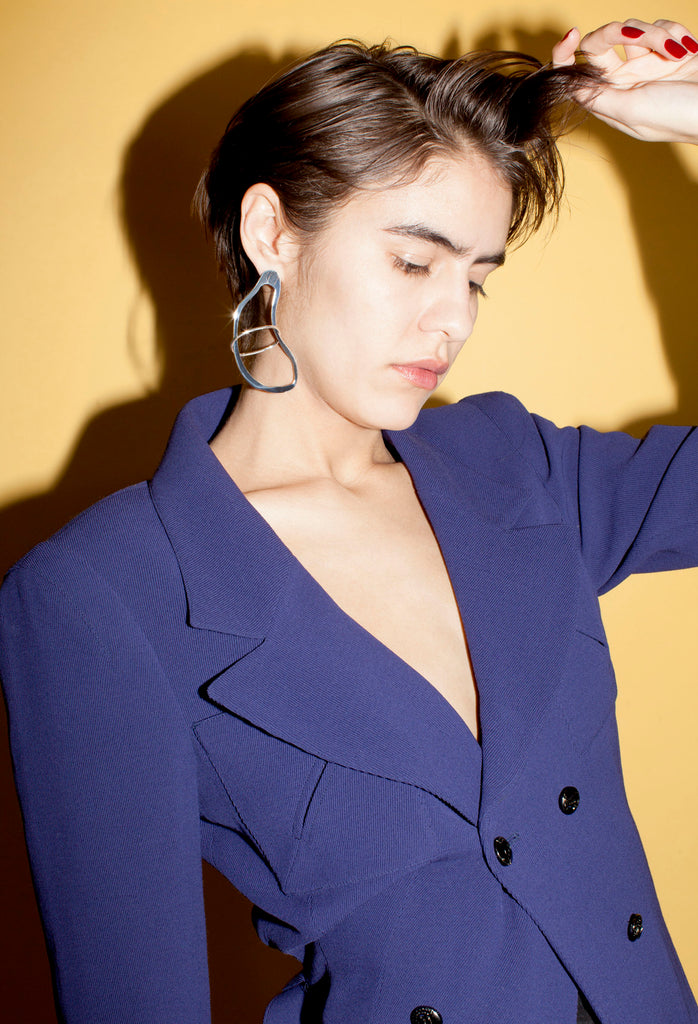 model in blazer and calamari earring.