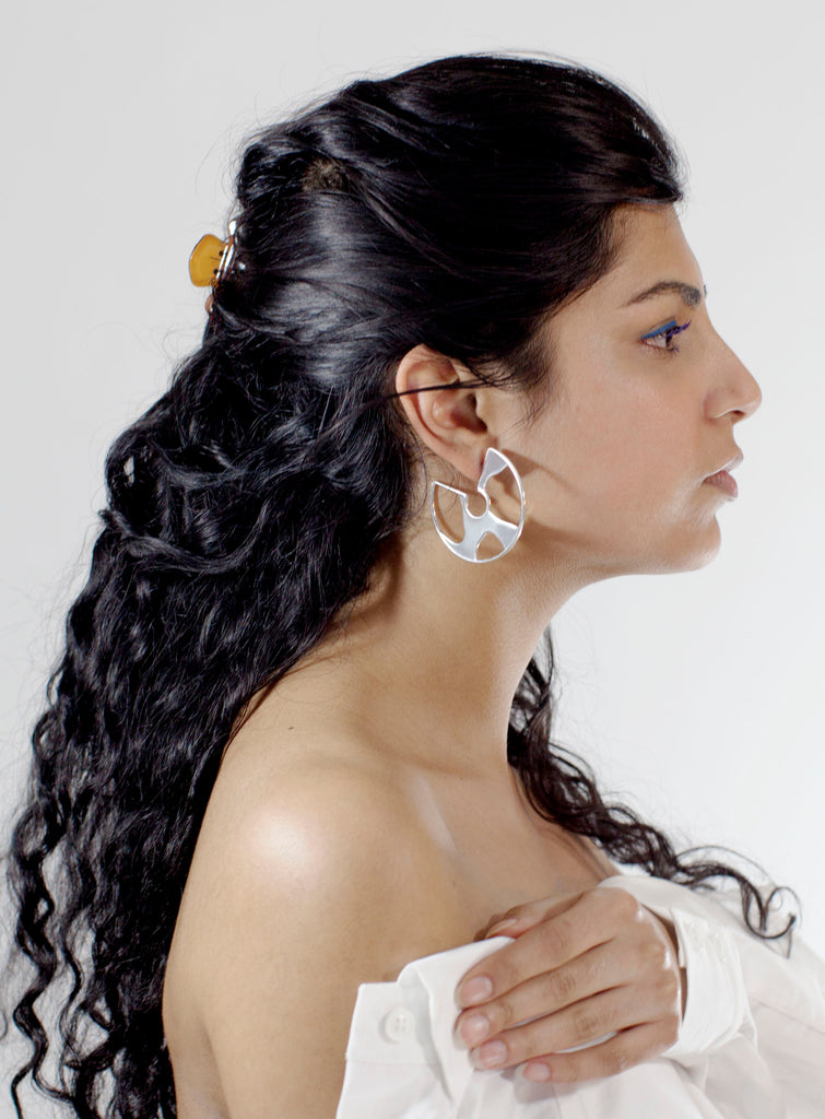 profile of model in earring. 