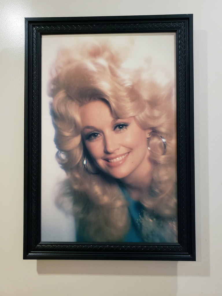 a portrait of young dolly in the wall.