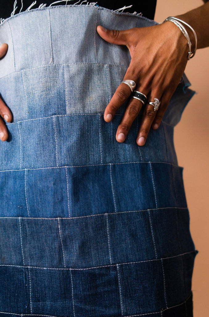 denzel sanders holding their patchwork denim.