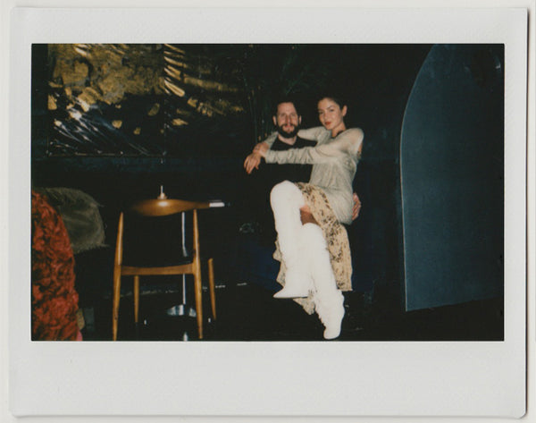 two people posing, one sitting on the other's lap – polaroid style.