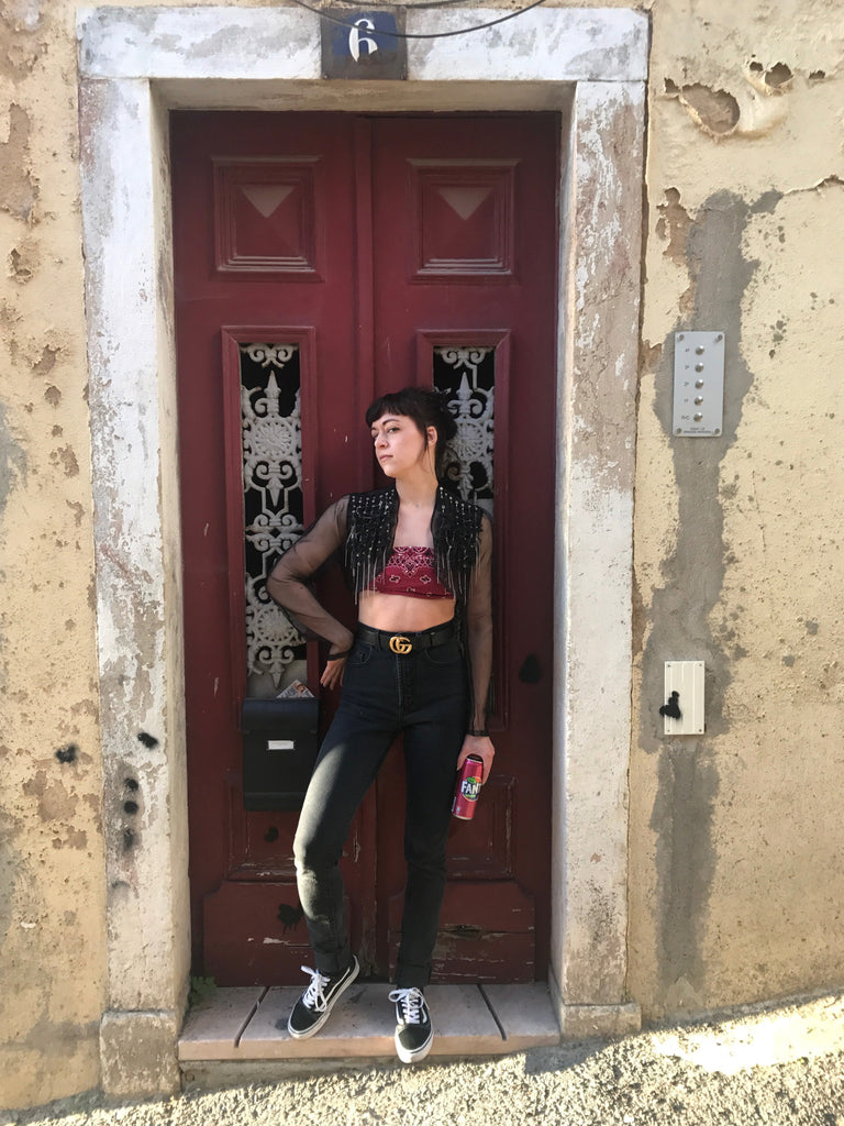 a person standing in front of a red door.