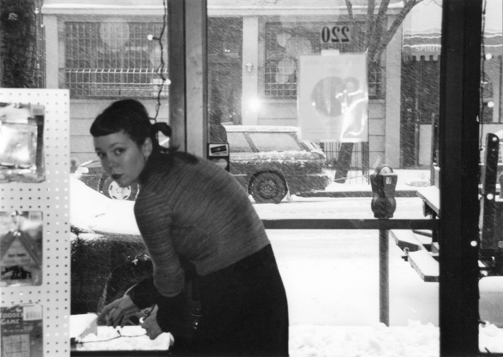 carrie, a woman with long dark hair, at first park slope location, tending to merchandise