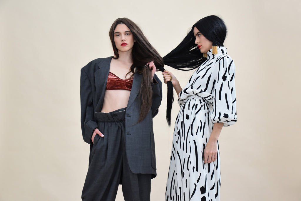 both models posing together with their hair intertwined.