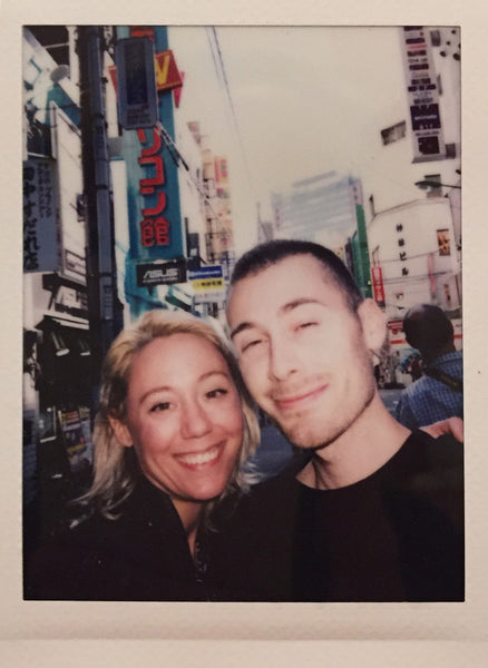polaroid of two people smiling at camera.