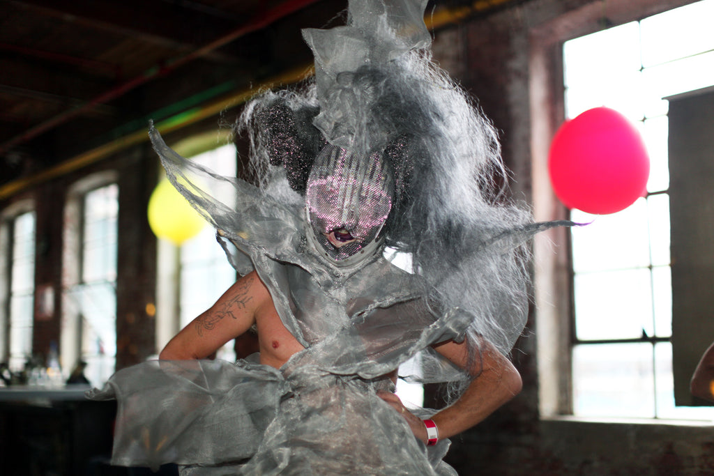 patron in wig and stunning conceptual dress and head piece. 