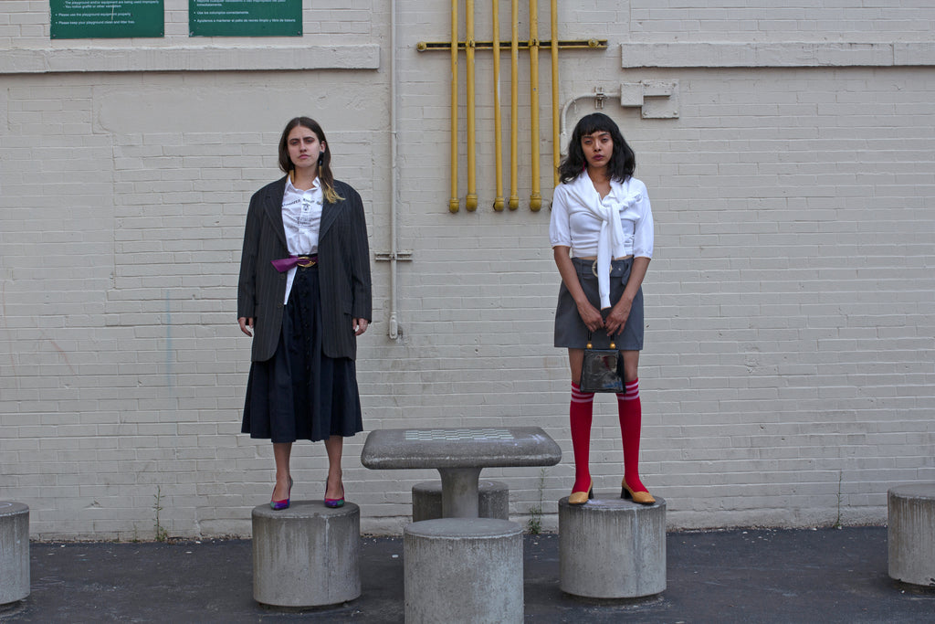 model standing on stone stool.