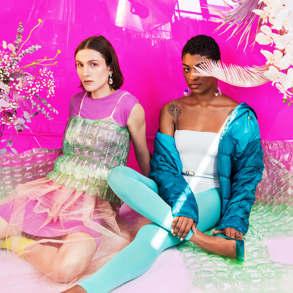 models in conceptual pastel styling with bubble wrap and fronds.