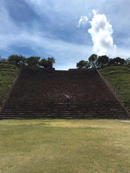 person posing at monte alban - ancient stairs, wide angle.